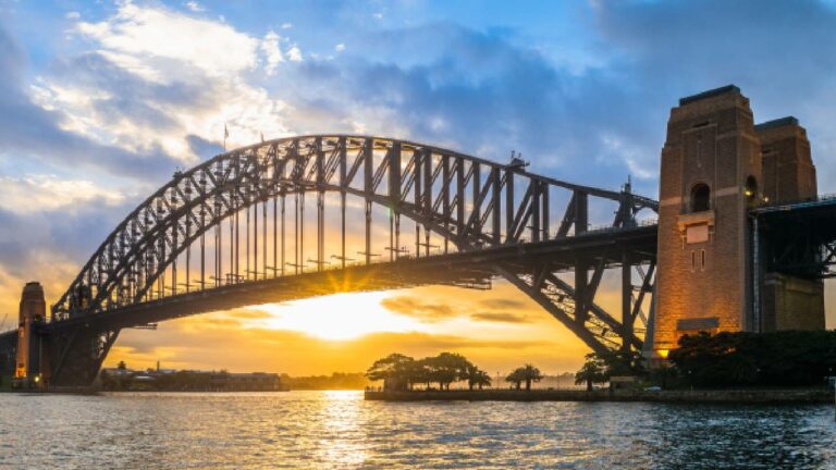 Sydney harbour bridge being backlit by a sunset