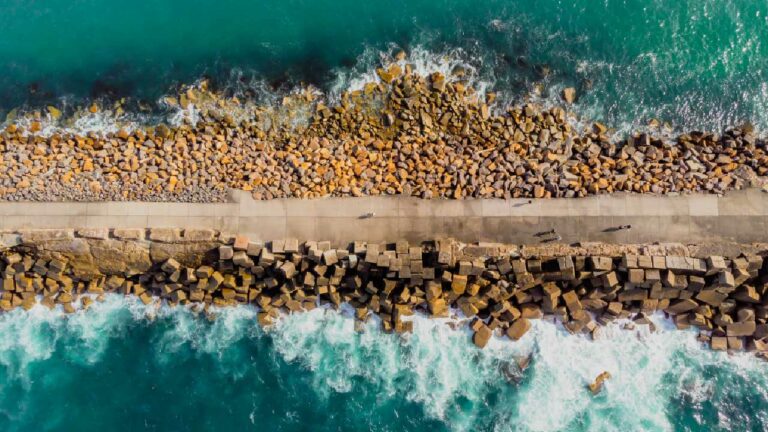 A top down shot of a breakwall with water on either side
