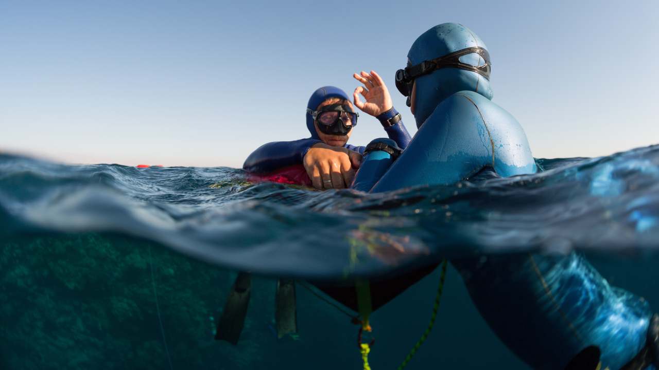 freedivers doing ok sign as freediving safety